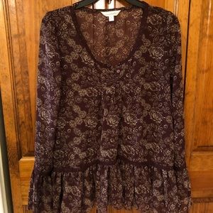 Burgundy floral top, bell sleeves.